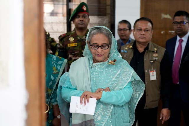 <p>File: Bangladesh Prime Minister Sheikh Hasina checks her watch as she waits for the official opening time to cast her vote in Dhaka </p>